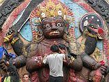 Kathmandu Durbar Square 05 04 Kala Bhairav Statue Hindu pilgrims touch the huge stone statue of Kala (black) Bhairav, Shiva's 6-armed destructive form, in Kathmandu Durbar Square. Atop his wide-eyed face is a crown decorated with human skulls, and on his back is a human skin. Kala Bhairav stands on a prostrate figure that represents human ignorance.